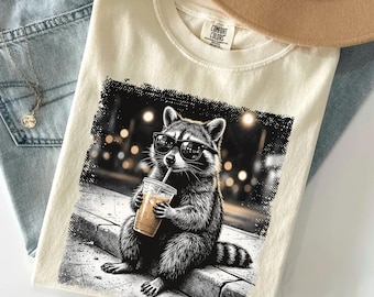 Funny Raccoon Shirt, Cool Trash Panda Tee, Iced Coffee Lover Tshirt, Cute Animal Graphic Top, City Night Sketch Gift, Humorous Coffee Top