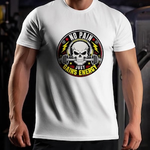 May include: White t-shirt featuring a circular graphic with a skull wearing headphones and holding a barbell. The graphic includes the text "NO PAIN" at the top and "JUST GAINS ENERGY" at the bottom, with lightning bolt accents.