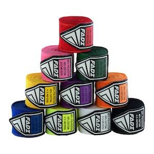 May include: A stack of colorful hand wraps for boxing or martial arts. The wraps are in various colors, including red, pink, green, yellow, purple, orange, blue, lime green, white, and black. Each wrap has a white label with the brand name "FADI" and the material composition.