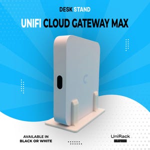 May include: A white desk stand for the Unifi Cloud Gateway Max. The stand is rectangular with a curved top and a small black oval on the side. The text "DESK STAND" and "UNIFI CLOUD GATEWAY MAX" are displayed. Available in black or white.