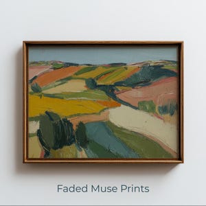 May include: An abstract landscape painting in a wooden frame. The artwork features rolling hills in shades of yellow, green, orange, and pink, with a light blue sky. The text "Faded Muse Prints" is at the bottom.