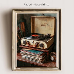 May include: A framed print featuring a vintage record player with a vinyl record on top. The record player is open, revealing its inner workings. A stack of vinyl records sits below the player. The print is labeled "Faded Muse Prints".