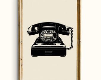 May include: Black and white print of a vintage rotary phone in a gold-colored frame. The phone has a classic design with a circular dial and a handset. The artwork is set against a cream-colored background.