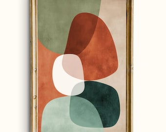 May include: Abstract art print in a gold frame. The artwork features overlapping organic shapes in shades of green, rust, white, pink, and teal against a beige background. The framed art piece is a modern wall decor item.