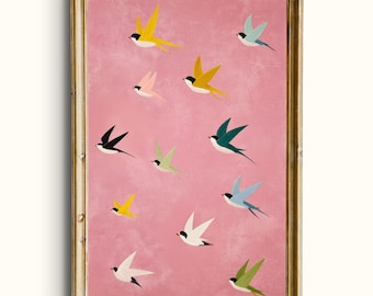 May include: A framed art print featuring a pink background with multiple colorful birds in flight. The birds are depicted in various colors, including yellow, black, green, and blue. The frame is gold-colored.