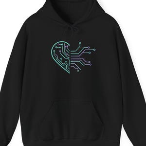 May include: Black hooded sweatshirt with a teal and purple circuit board heart design. The graphic is on the front of the hoodie. The sweatshirt has a front pocket and a drawstring hood.