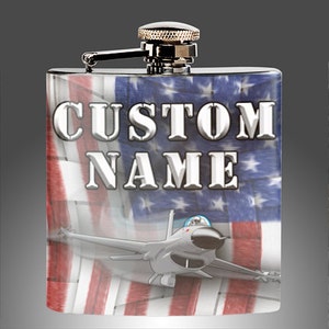 May include: Stainless steel flask with a custom name and an American flag design featuring a fighter jet.