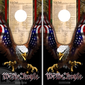 May include: A pair of cornhole boards with a patriotic design. The boards are decorated with an American flag, a bald eagle, and the words "We the People".