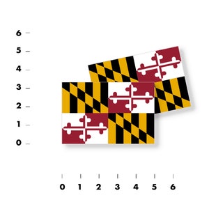 May include: Two Maryland state flags, one on top of the other, with the yellow and black checkered pattern and the red and white cross in the center.