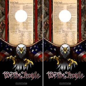 May include: A black and red camouflage background with a bald eagle with outstretched wings. The eagle is holding a US flag in its talons. The text "We the People" is written in a bold, red font at the bottom of the image. The text "AmmoCanDecals" is written in a smaller font below the main text.