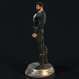 May include: A black and white statue of a superhero in a dynamic pose. The figure is clad in a black suit with a white emblem on the chest. The statue stands on a silver and gold circular base, showcasing detailed musculature and a determined expression.