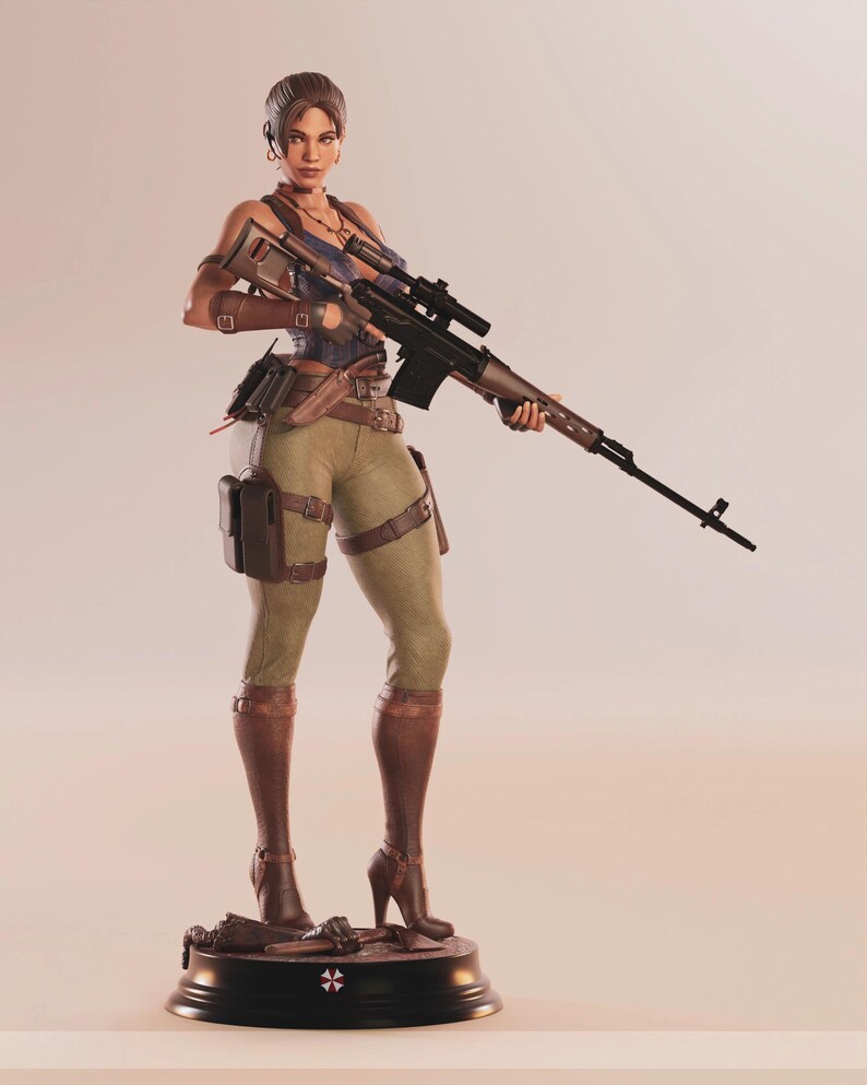 May include: A detailed figurine of a woman in combat attire, holding a rifle. She wears a blue top, olive green pants, and brown boots. The figure stands on a black base with a symbol. The rifle has a scope and a wooden finish.