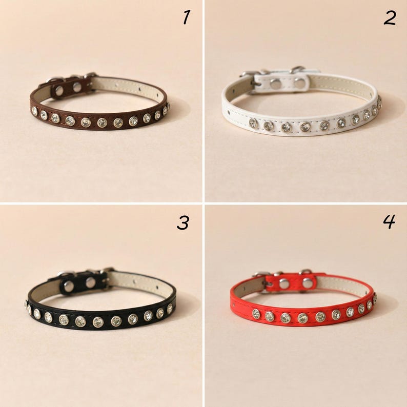 May include: Four pet collars in brown, white, black, and red, each featuring a row of clear circular rhinestones, a silver-toned metal buckle, and a light-colored interior lining. The collars are numbered one through four in the corners.
