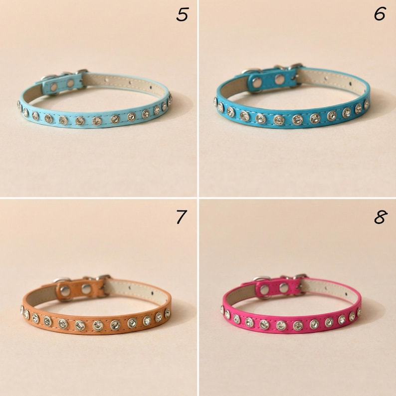 May include: Four pet collars in light blue, bright blue, tan, and hot pink. Each collar features a row of embedded clear rhinestones, a silver-toned metal buckle, and a matching metal loop. The collars are numbered 5, 6, 7, and 8 respectively.