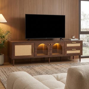 May include: A dark brown wooden TV stand with a black screen television on top. The stand features woven cane door and drawer fronts, arched glass doors, and gold-toned hardware. The stand is 183 cm long.