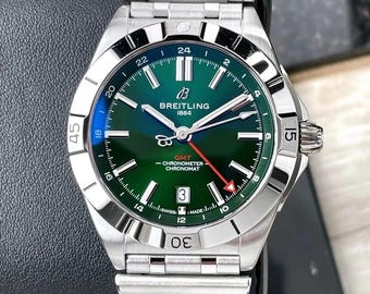 Reloj Breitling Chronomat GMT automático vintage con esfera verde y brazalete de acero para hombre.