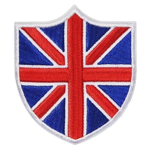 May include: Embroidered patch in the shape of a shield, featuring the Union Jack, the national flag of the United Kingdom. The design includes a red cross and diagonal stripes on a blue background, with a white border.