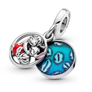 A silver charm bracelet with a pendant featuring a character from the Disney movie Lilo and Stitch. The pendant is a circular design with a blue background and a pattern of blue and white polka dots.