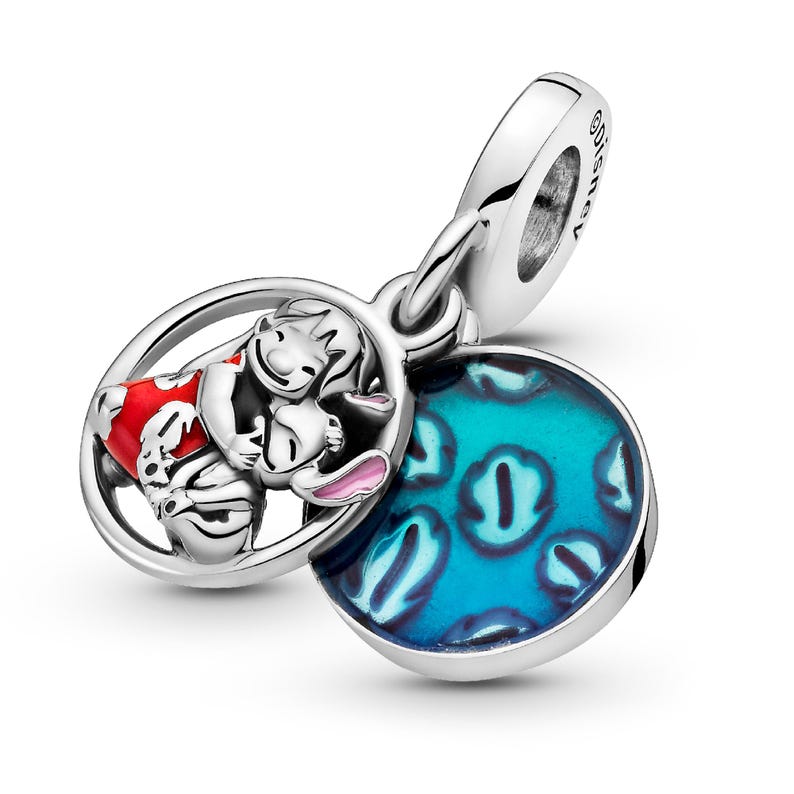 A silver charm bracelet with a pendant featuring a character from the Disney movie Lilo and Stitch. The pendant is a circular design with a blue background and a pattern of blue and white polka dots.