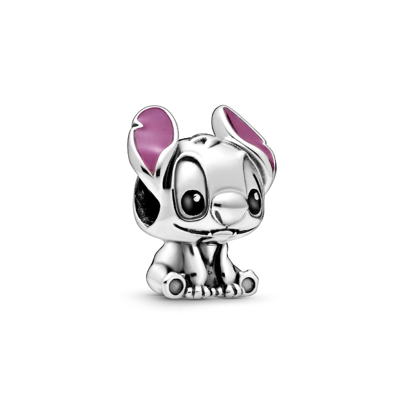 A small, silver-colored charm in the shape of a cartoon character with large eyes and pink ears.