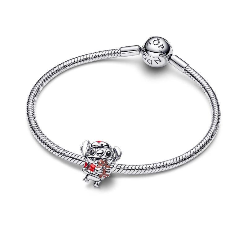A silver bracelet with a charm attached to it.