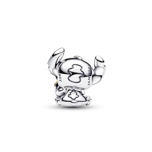 A silver-colored charm in the shape of a cartoon character, with the text "STELLA" visible on it.