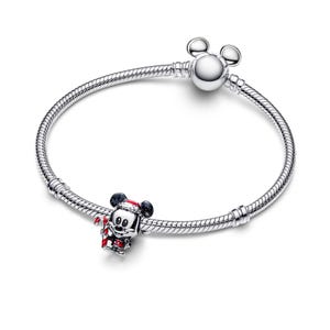 A silver bracelet with a charm featuring a cartoon character, likely Mickey Mouse, and a ball.