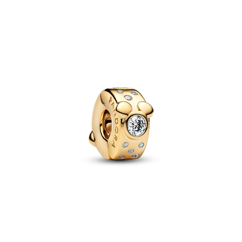 A gold-colored charm bracelet with a central pendant featuring a crystal or gemstone.