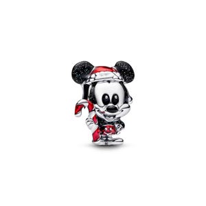 A shiny, metallic charm in the shape of a cartoon character, resembling Mickey Mouse, is shown against a white background.