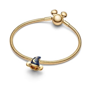 A gold bracelet with a charm in the shape of Mickey Mouse's hat.