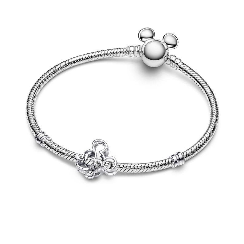 A silver bracelet with a charm and a ball at the end.
