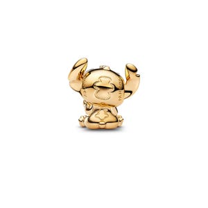 A shiny gold-colored charm in the shape of a cartoon character, resembling Stitch from the Disney movie "Lilo & Stitch".