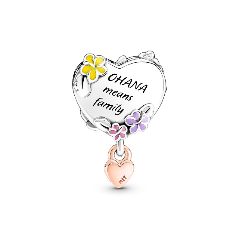 A heart-shaped charm with the text "OHANA means family" written on it, surrounded by colorful flowers.