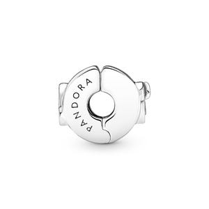 A silver-colored earring with the word "PANDORA" engraved on it.