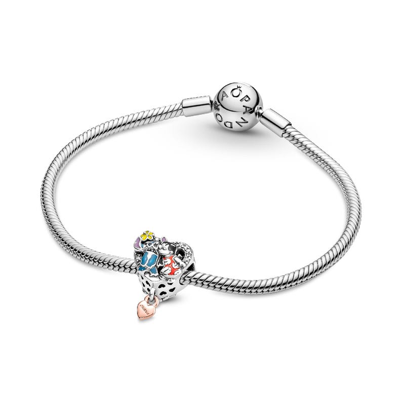 A silver-toned bracelet with a charm and a bead on it.
