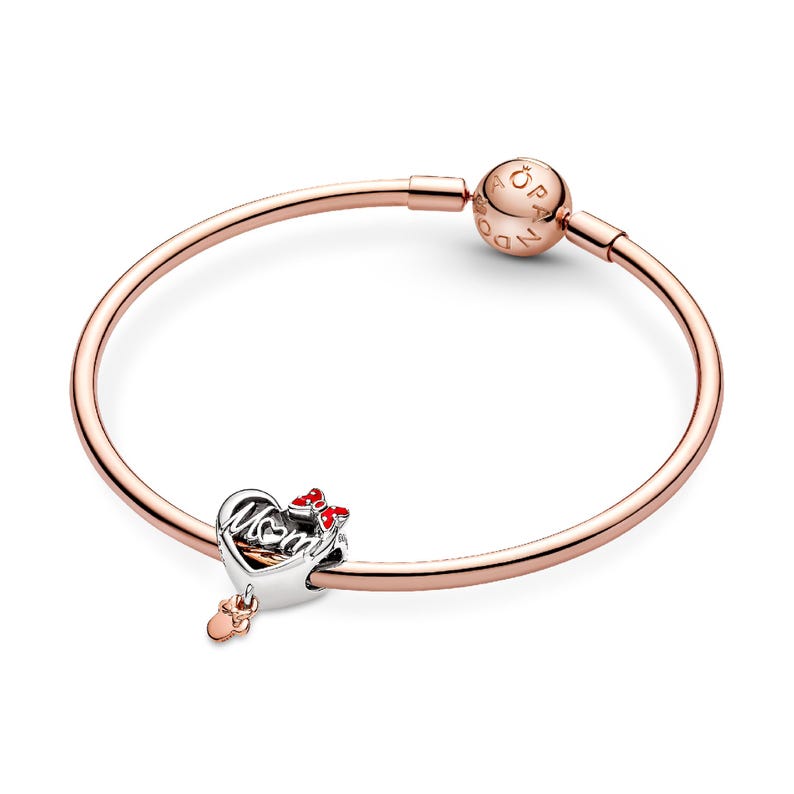 A rose gold-colored bracelet with a charm attached to it.