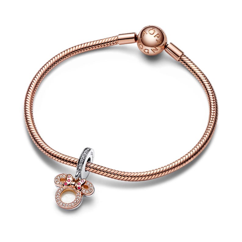 A rose gold-colored bracelet with a charm pendant and a ball clasp.
