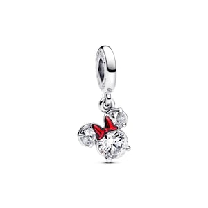 A silver charm bracelet with a red bow and three sparkling gemstones.