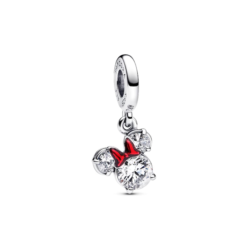 A silver charm bracelet with a red bow and three sparkling gemstones.