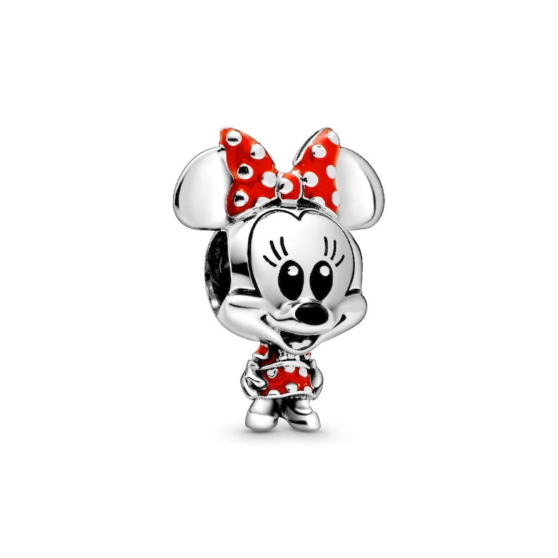 A silver-colored charm in the shape of Minnie Mouse, with red polka dots and a bow around her head.