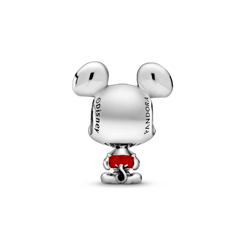 A silver charm in the shape of a cartoon mouse with a red bow around its neck.