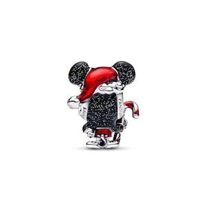 A shiny, metallic charm in the shape of a cartoon character, possibly a character from Disney or a similar franchise, wearing a red hat and holding a red and black striped object.