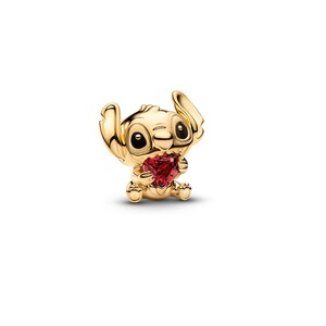 A gold-colored charm in the shape of a cartoon character holding a red heart.