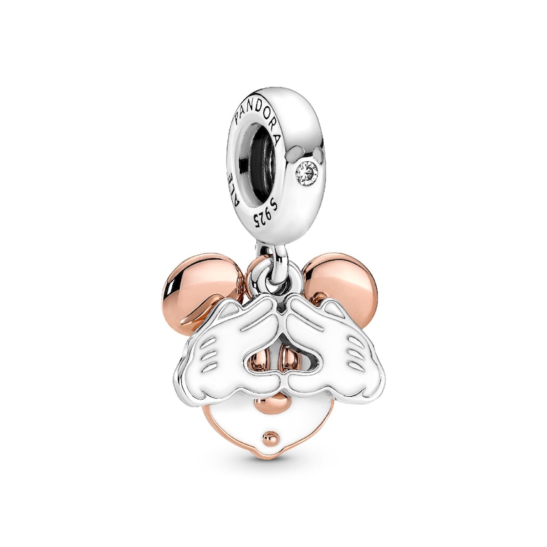 A silver and gold pendant charm in the shape of a cartoon mouse, with a heart-shaped charm attached to it.