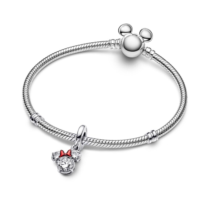 A silver bracelet with a charm featuring a Minnie Mouse design.