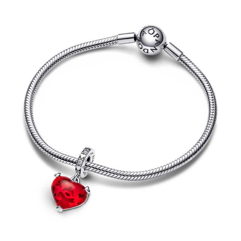 A silver-toned bracelet with a red heart-shaped charm and a silver-toned bead attached to it.