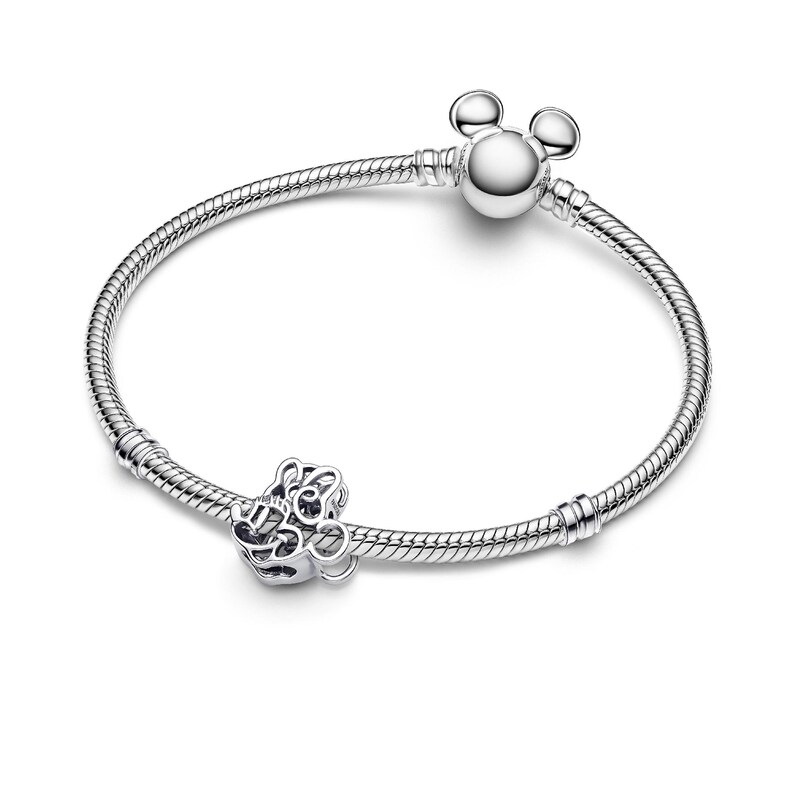 A silver bracelet with a charm and a loop, featuring a design reminiscent of Mickey Mouse ears.