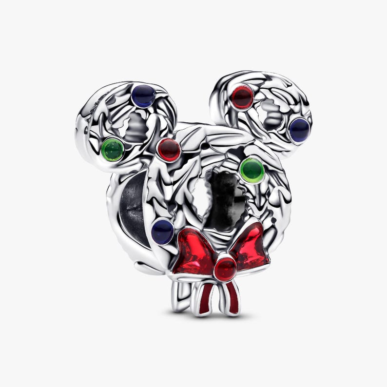A silver-colored charm bracelet with a wreath-like design and colorful gemstones.
