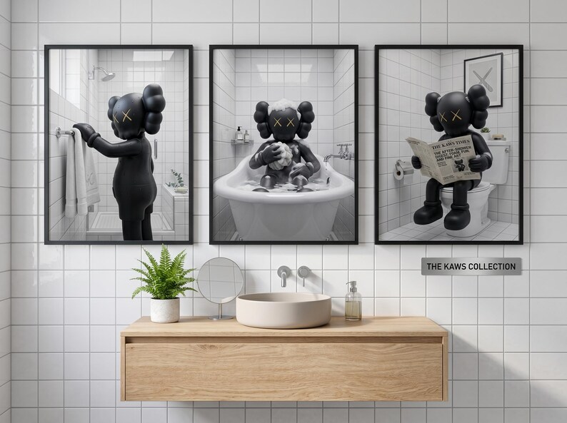 May include: A set of three framed wall art prints featuring a black KAWS character in a white-tiled bathroom. The left print shows the character reaching for a towel, the center shows it in a bathtub, and the right shows it reading a newspaper.