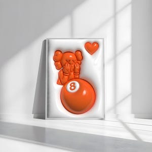 May include: Orange artwork in a white frame. The artwork features a cartoon figure covering its face, a heart, and an orange eight ball. The background is white.